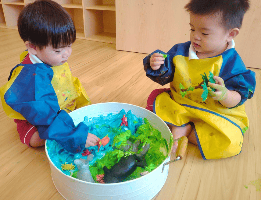 Young toddlers explore textures and imagination through colorful sensory on Earth Day!