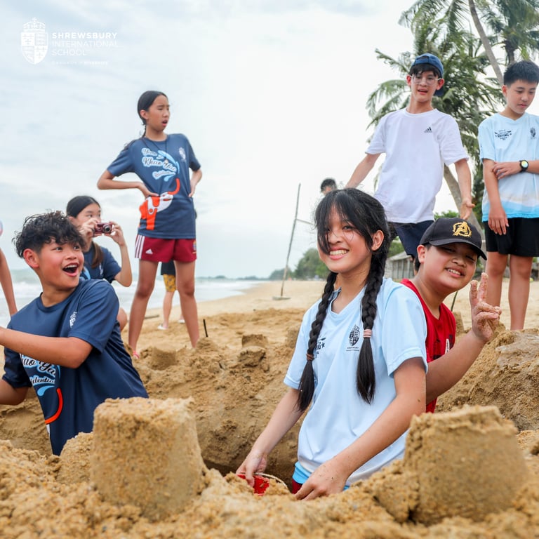 Students building sandcastles during residential week.