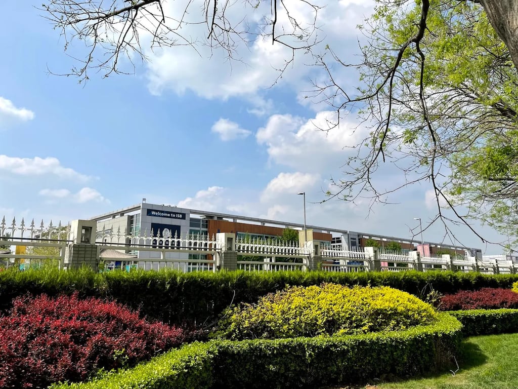 Landscaped gardens and perimeter view of the International School of Beijing campus.
