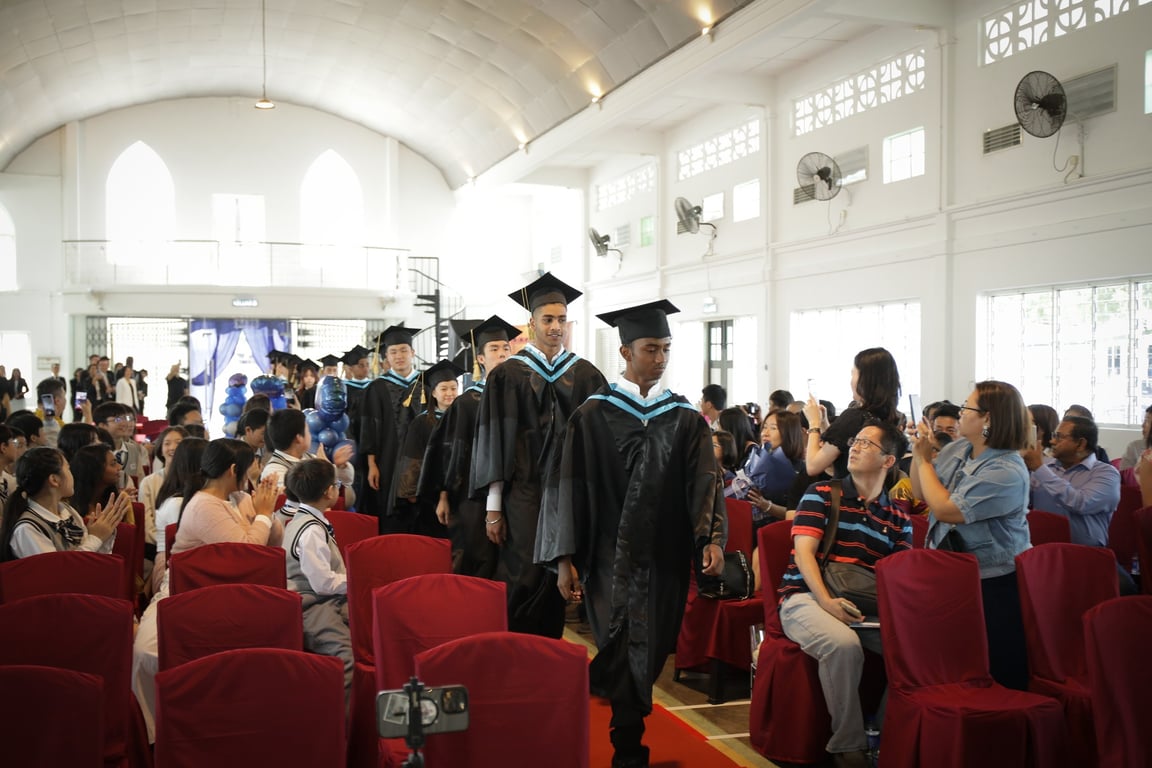 Graduating students entering the hall during the commencement ceremony.