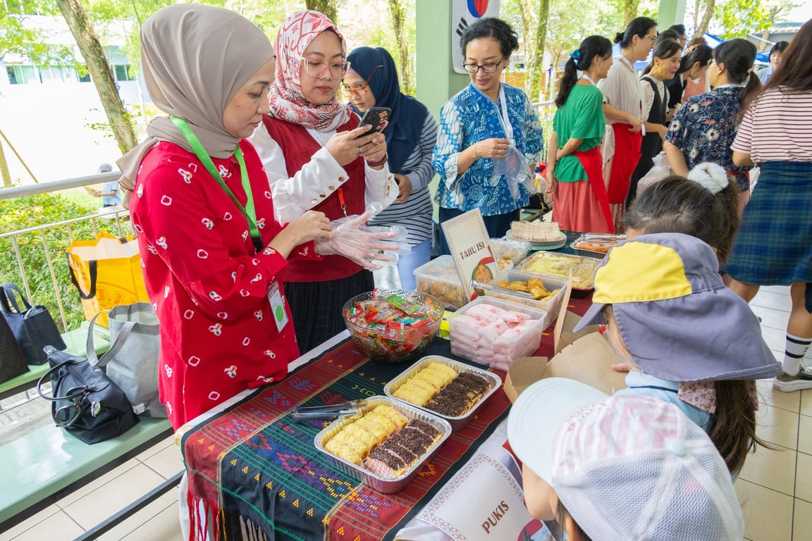 Students explore traditional snacks at a booth during the World Food Tour.
