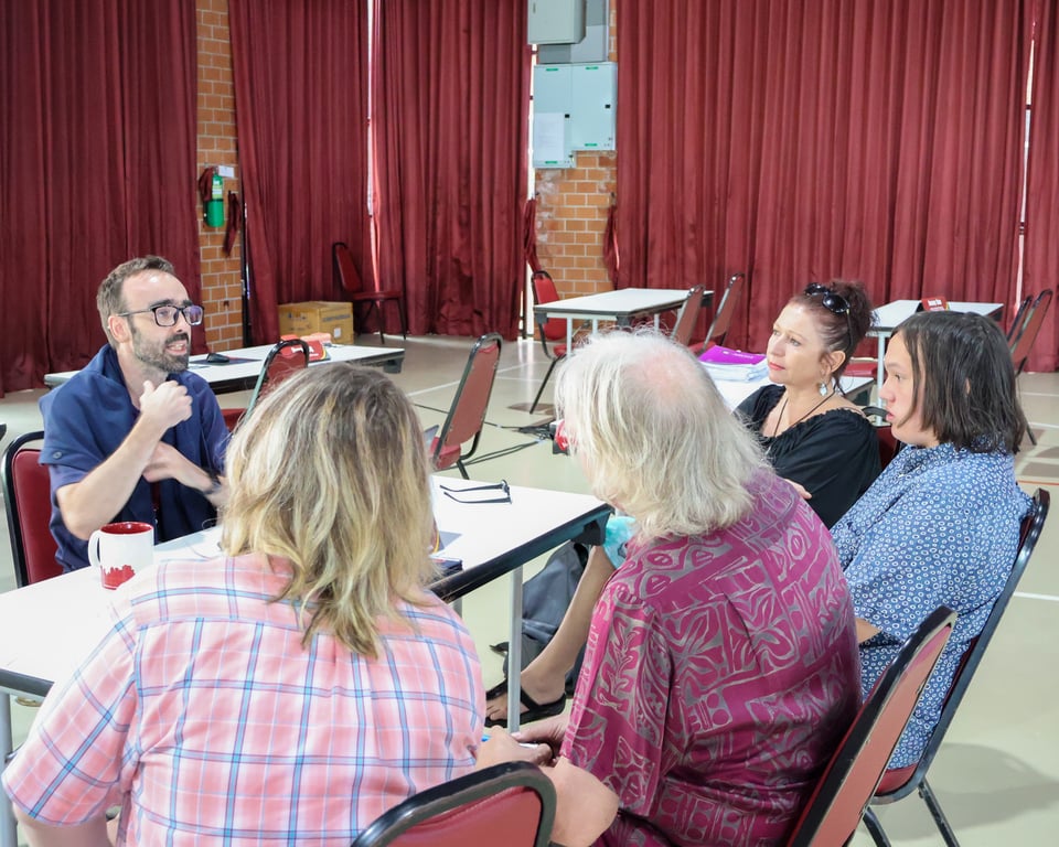 Parents and staff discussing during the school’s parent meeting.