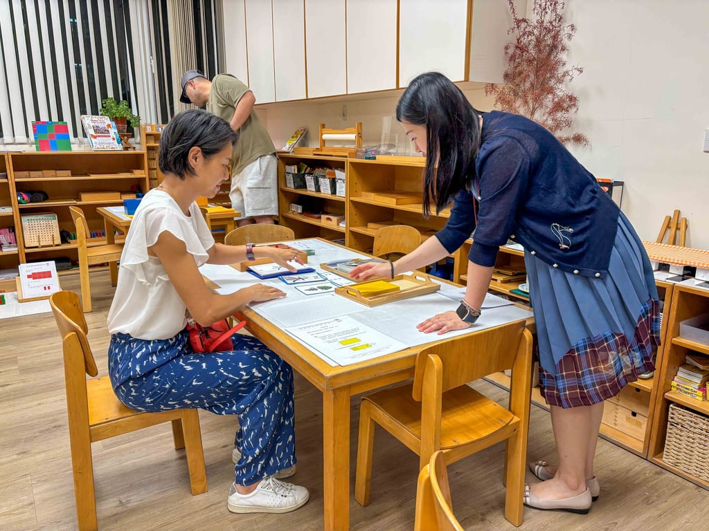Parents exploring Montessori learning materials during classroom evening.