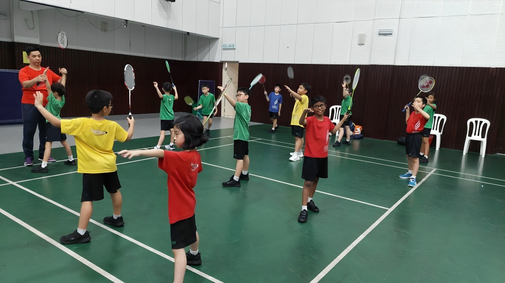 Badminton session in progress. Group training session builds coordination and teamwork on the court.