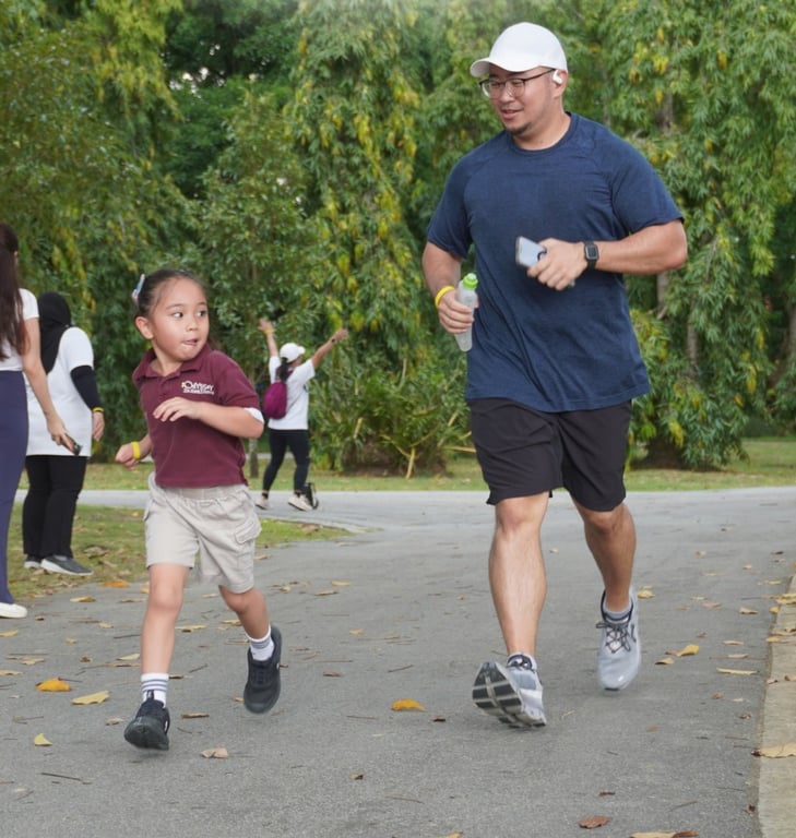 A father and daughter participating in a run to promote an active lifestyle.