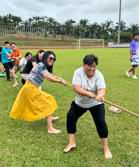 Parents participating in activities on sports day.
