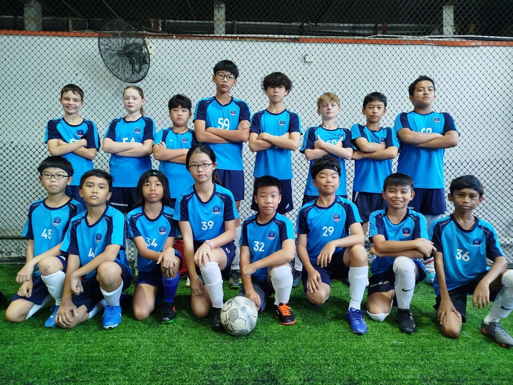 The school’s football team poses together after a match, showcasing teamwork and school spirit.