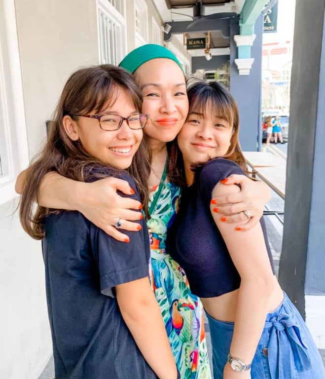 A happy parent and her daughters satisfied with the school's services. 