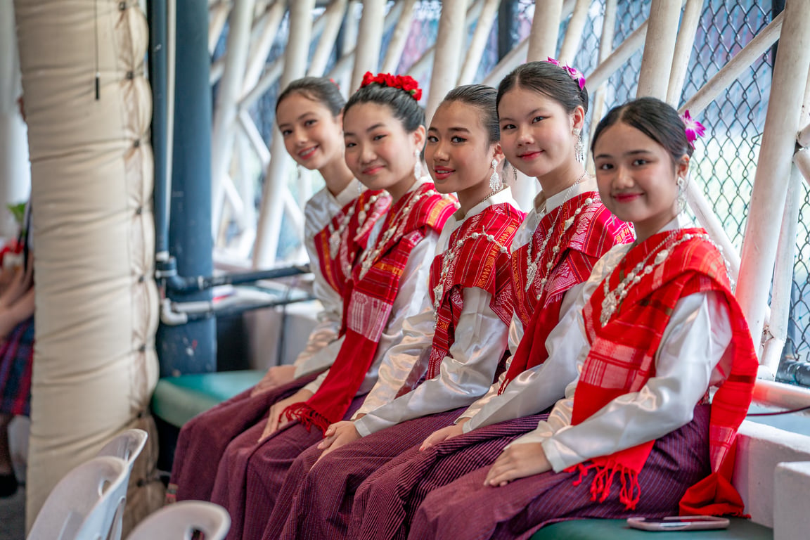 Students wear traditional attire as part of a cultural celebration at school.