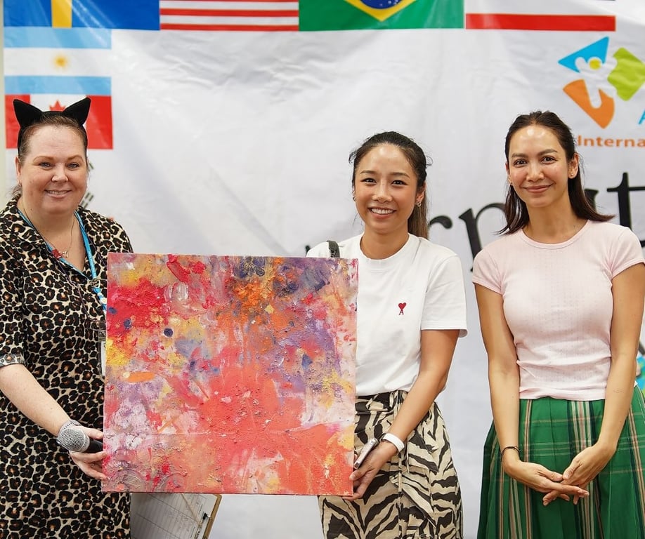 A teacher and parents posing at an event.