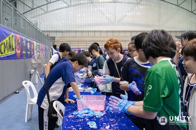Students creating oobleck during the UCIS 2025 Science Fair.