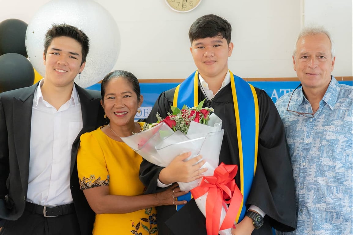 Graduate poses with family during a school celebration ceremony.