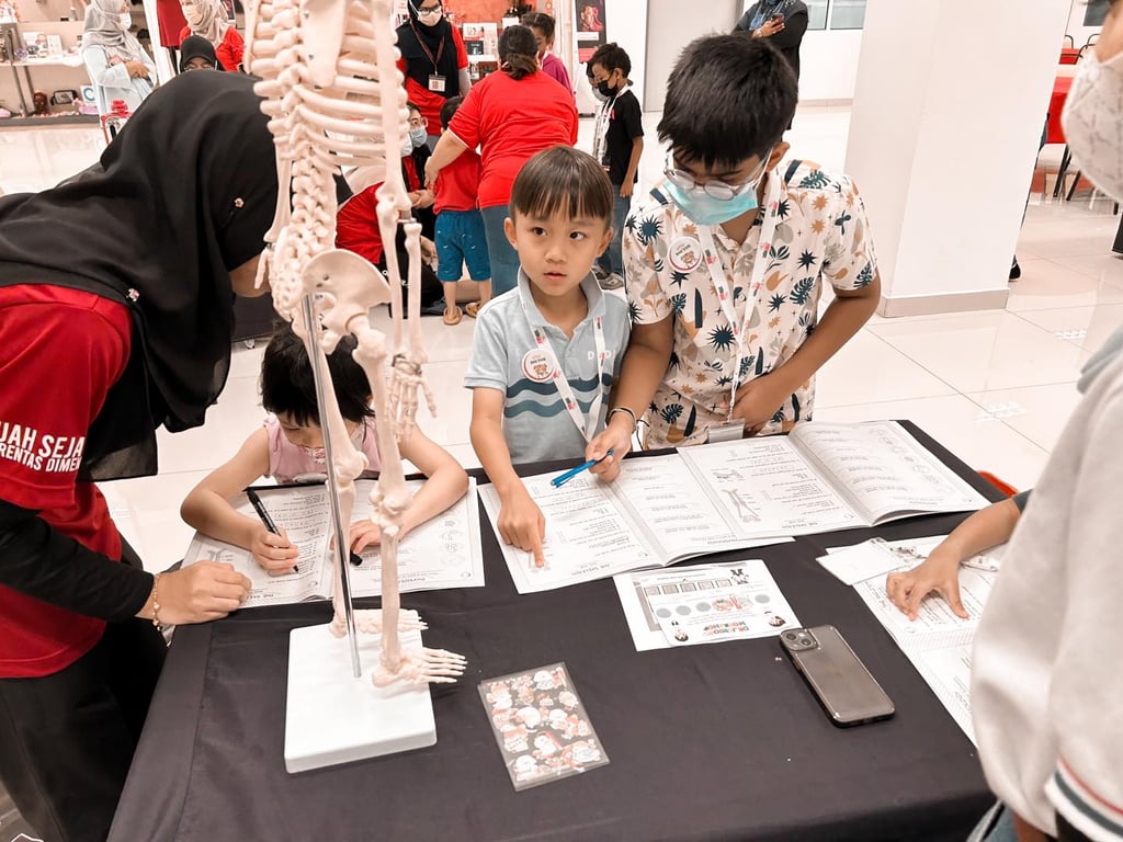Students explore human anatomy during a science exhibition, engaging with interactive displays and educational games.