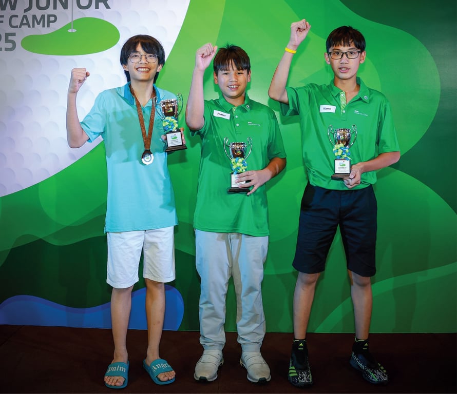 Junior golfers celebrate trophies at golf camp event.