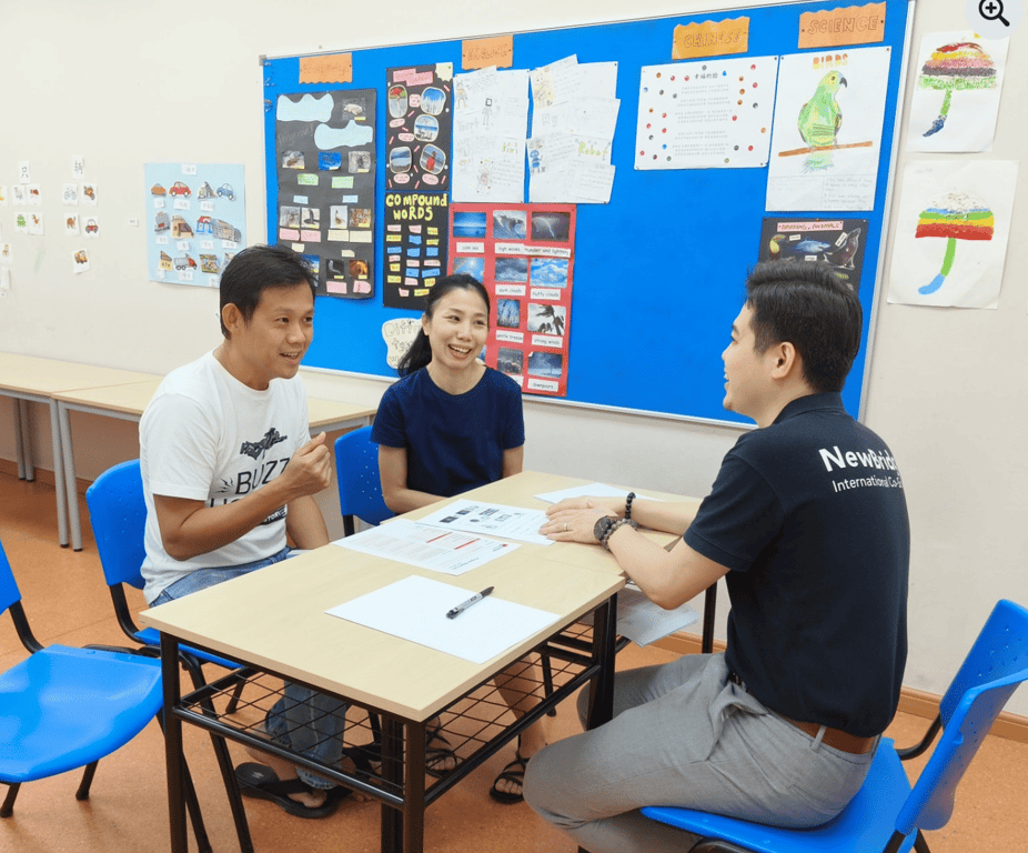 A teacher discussing about the child's progression with parents.