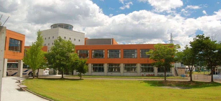 An exterior view of the bright orange academic wing at Tohoku International School.