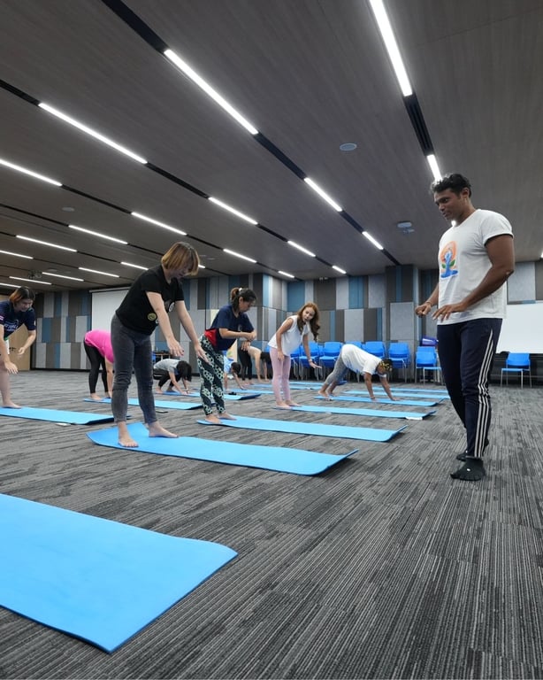 Students, parents, and staff join a yoga session for International Yoga Day.