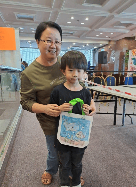 A snippet of a parent with their child at the art showcase.
