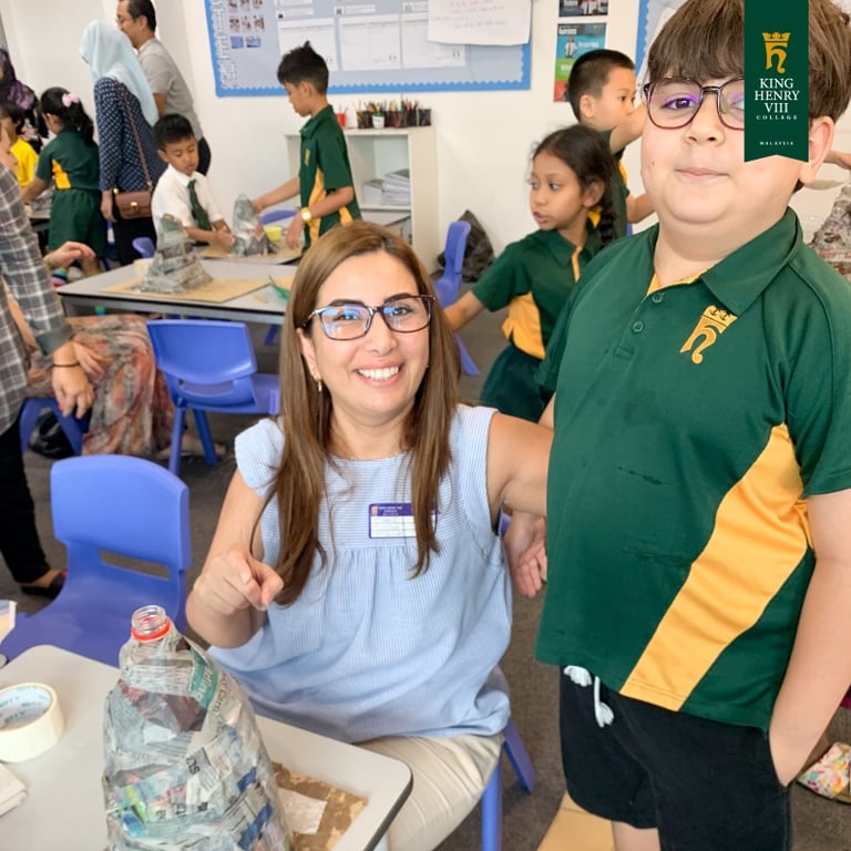 Year 3 students and parents collaborating on final volcano projects.