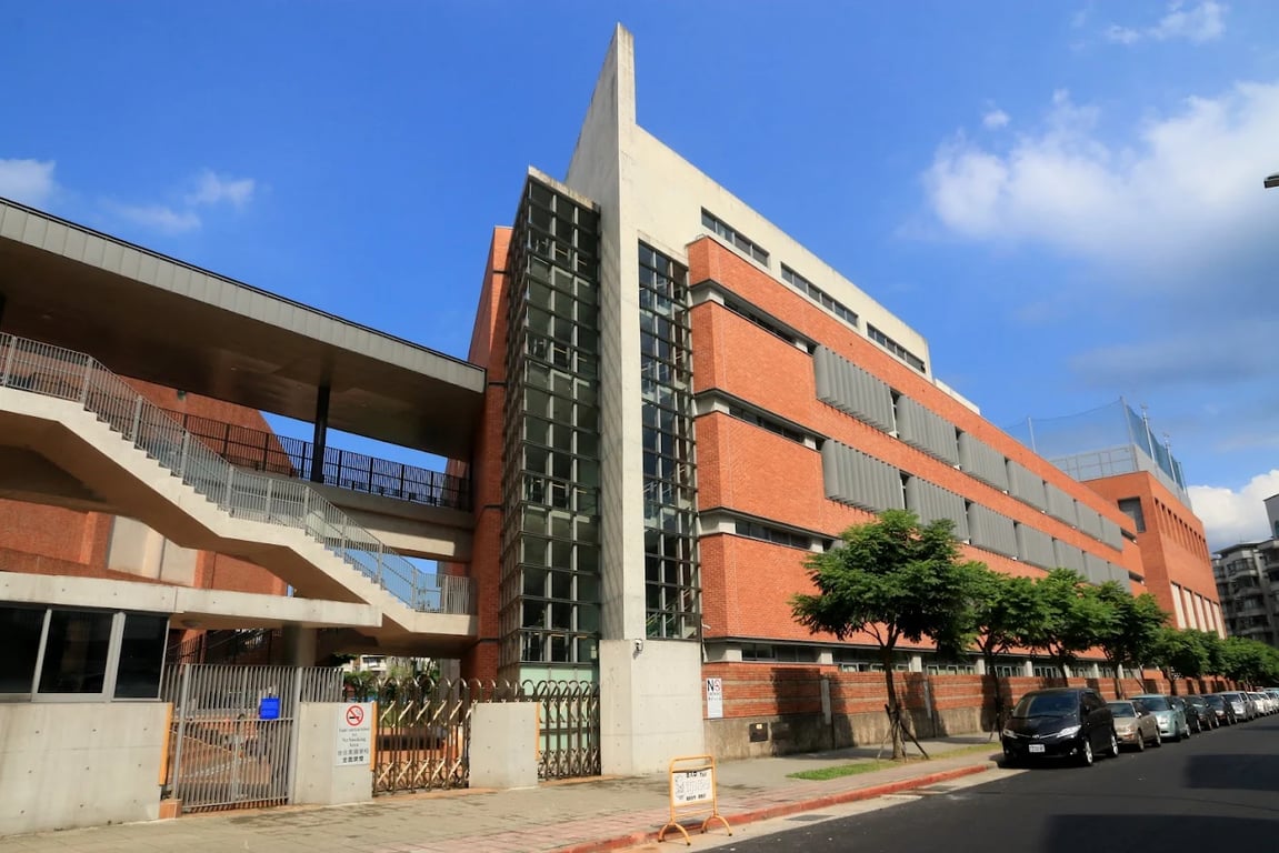 Red brick facade of the Taipei American School academic building.
