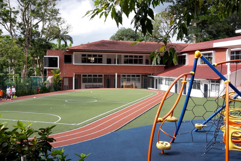 A view from the back of the school, showing the recreational and sports areas, as well as the main buildings.