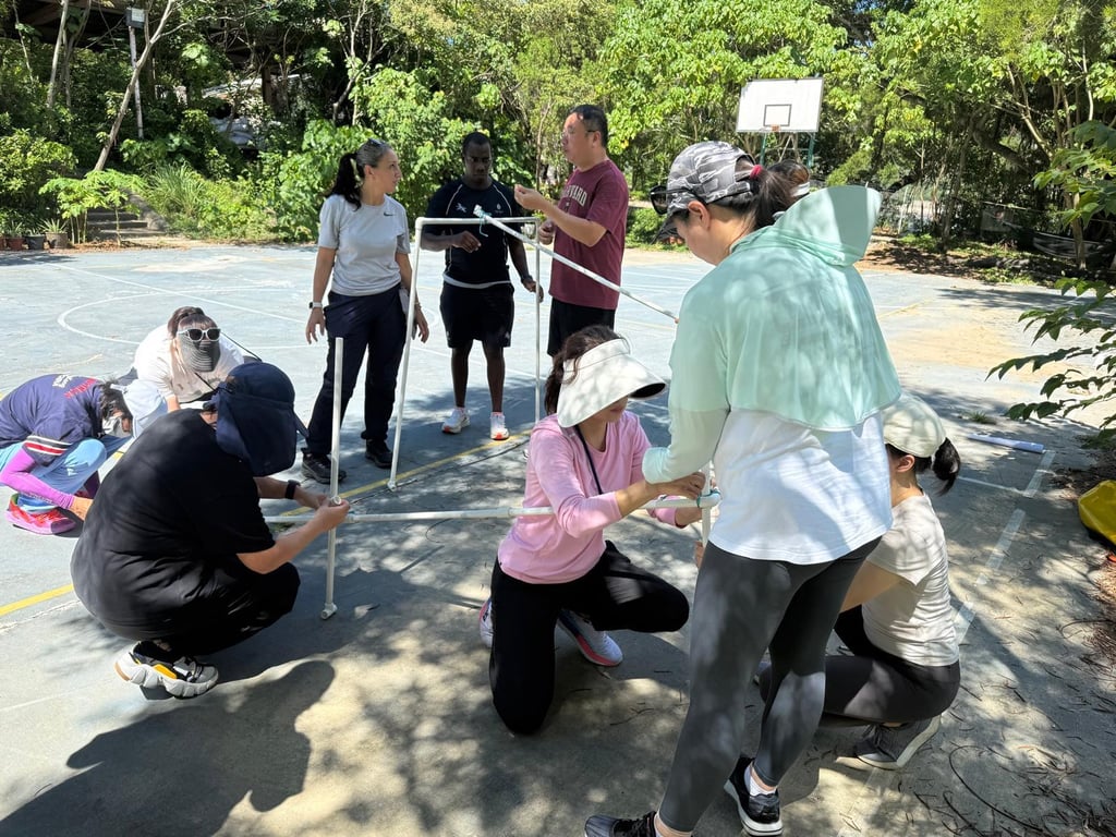 Parents collaborating during a team-building challenge at Shek Pik.
