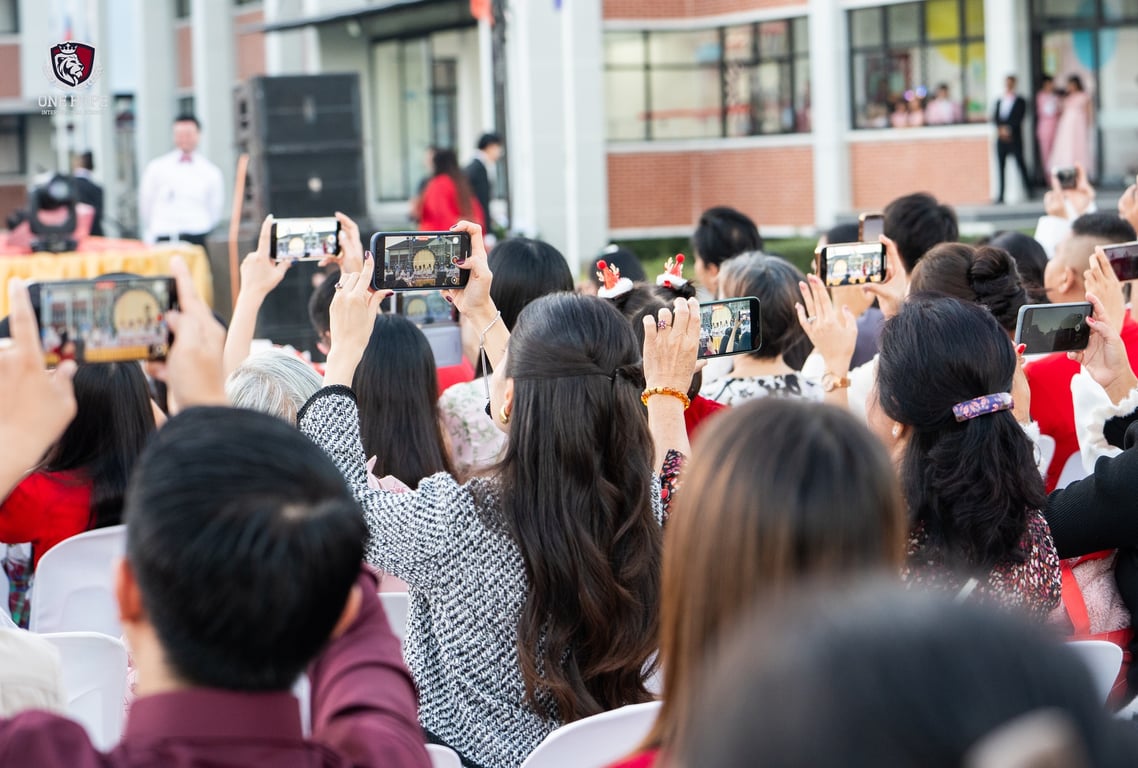 Parents recording the performances during the Christmas event.