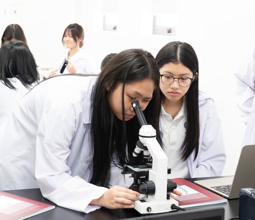 Students using a microscope during a science class.