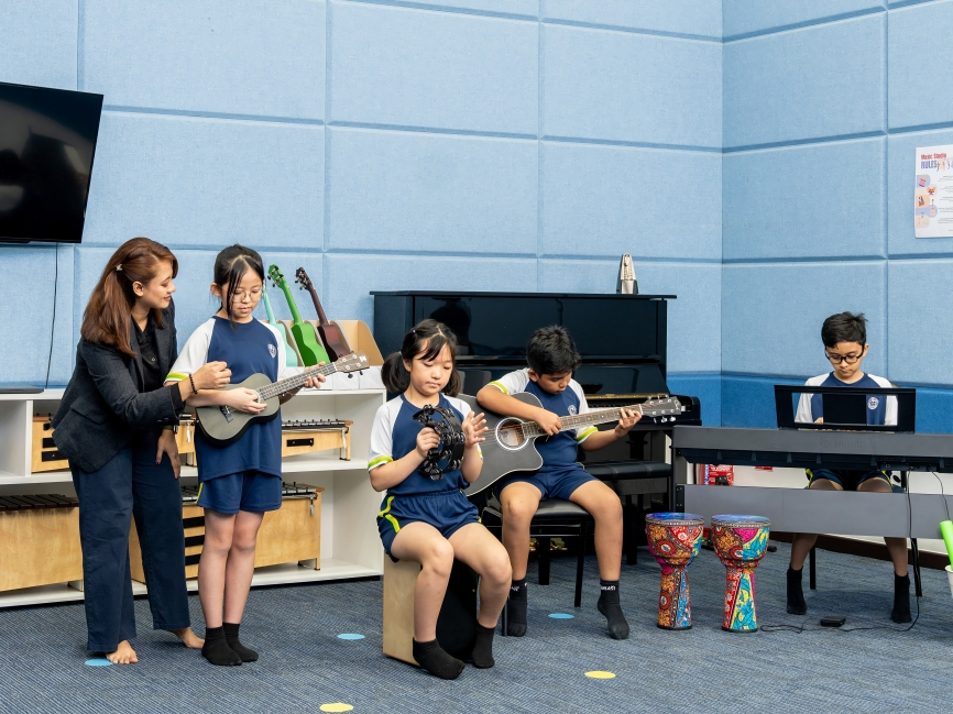 A group of budding musicians practice rhythm and melody with their instruments.