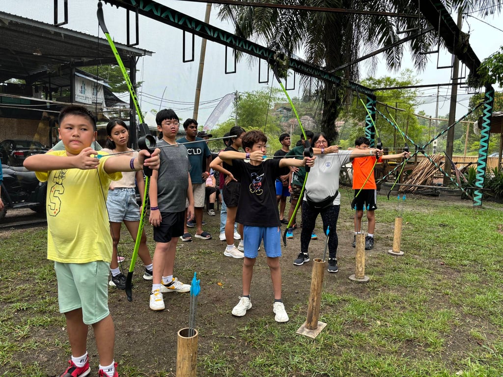Students take aim during an archery session, part of their outdoor education experience.