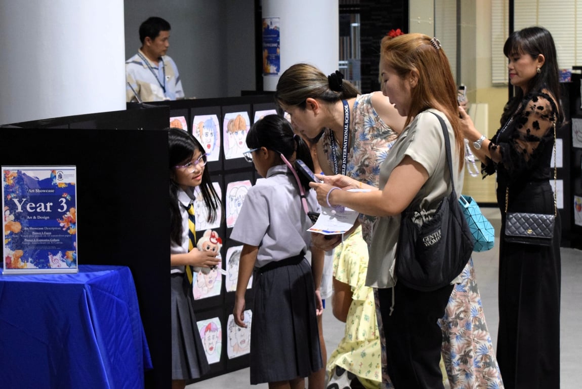 Students proudly presenting their creative work to visiting parents, sparking engaging conversations and curiosity.