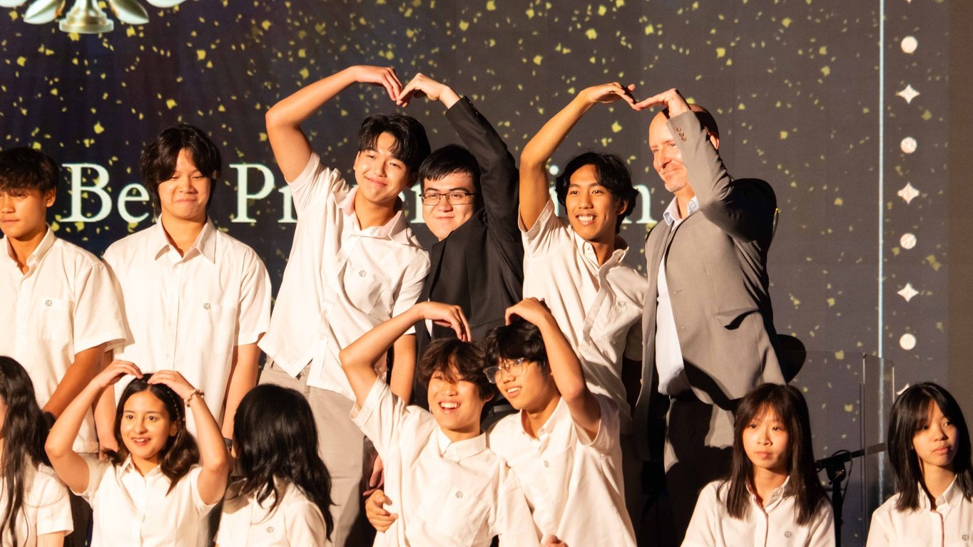 Students and teachers celebrating together at the end-of-term ceremony.