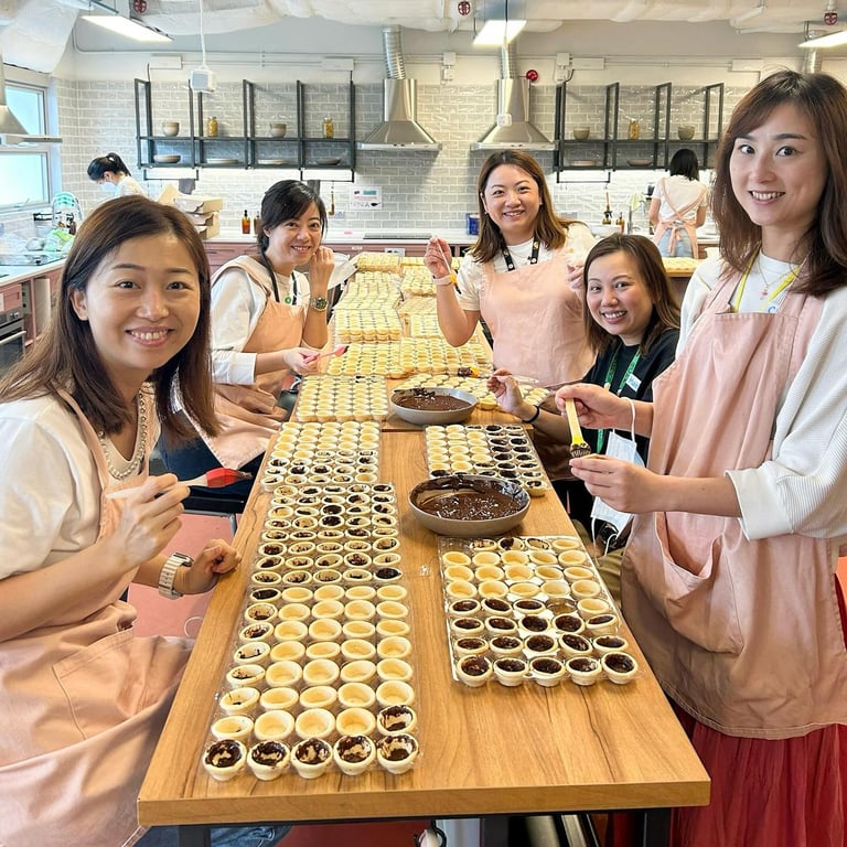 Parent volunteers preparing chocolate-filled tarts for Joyful Fruit Day 2024.