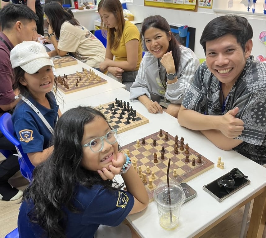 Students and parents enjoying a friendly chess tournament.