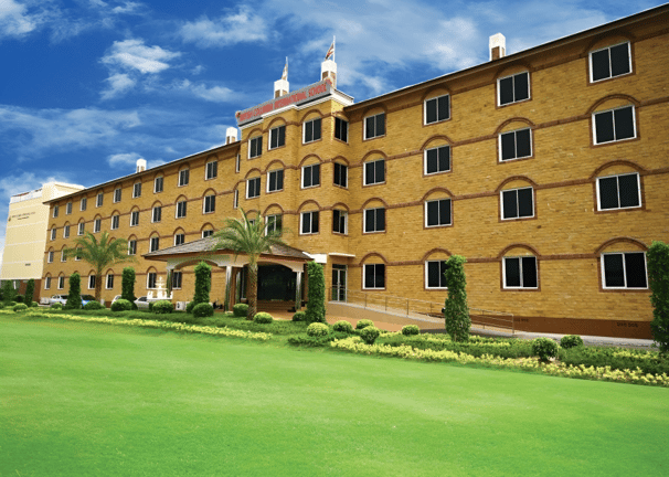 School campus view with spacious green surroundings.