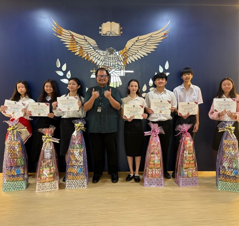 Students receive certificates and hampers in recognition of academic achievement at a school awards ceremony.