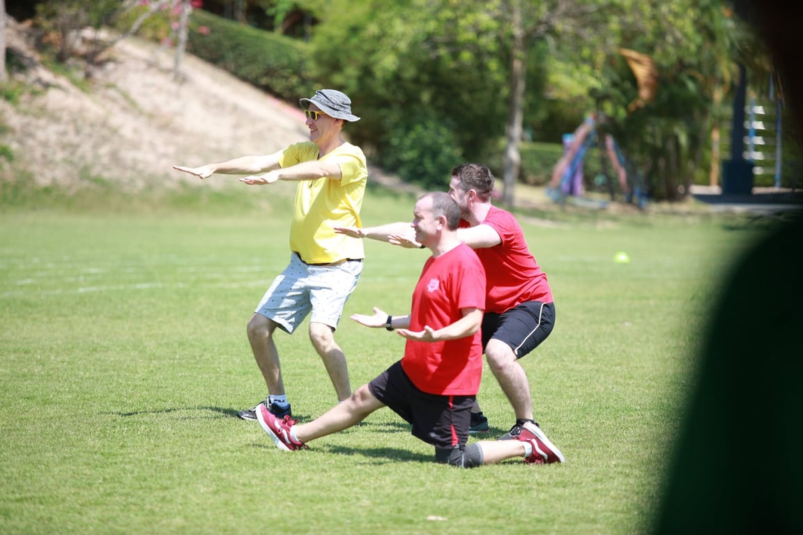 Staff participating in an outdoor Sports Day event.