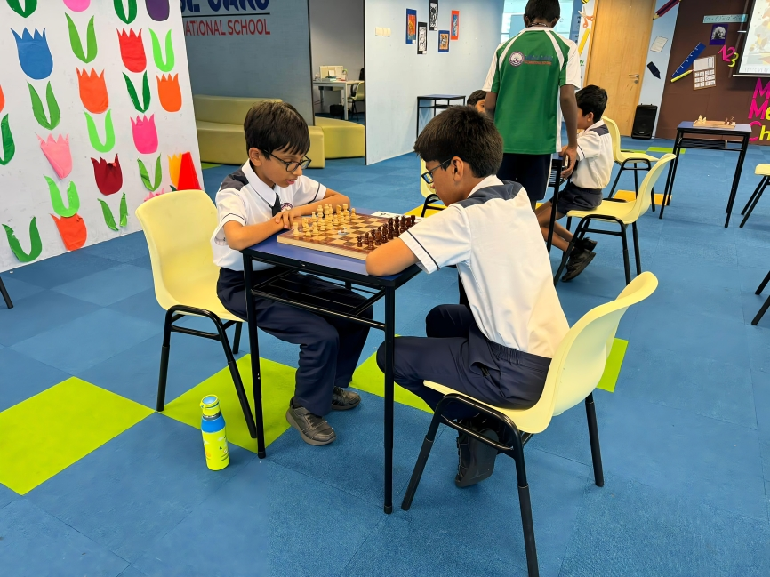 Students focus intensely during a chess match as part of their co-curricular activities.