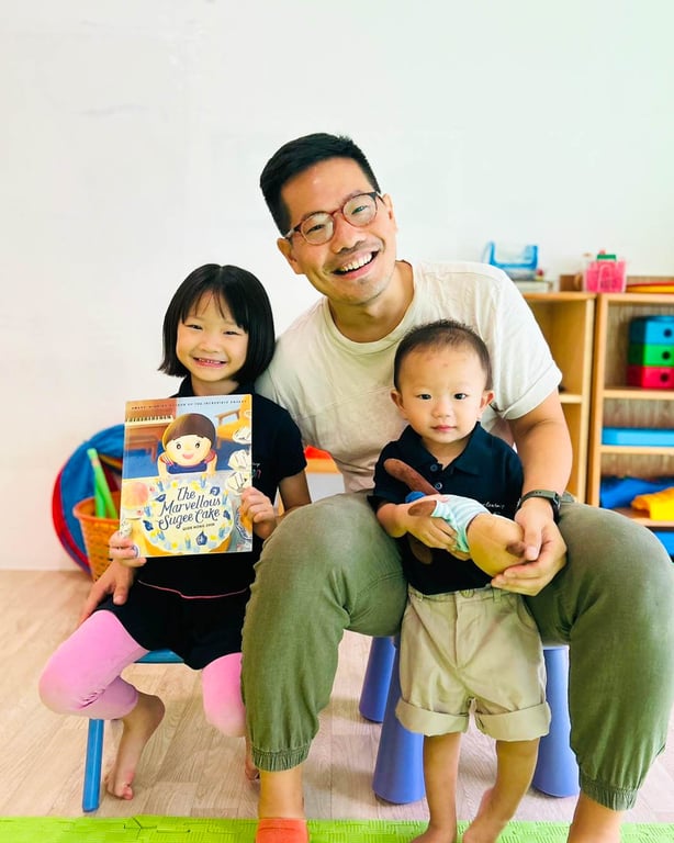 A parent posing with their children for the 