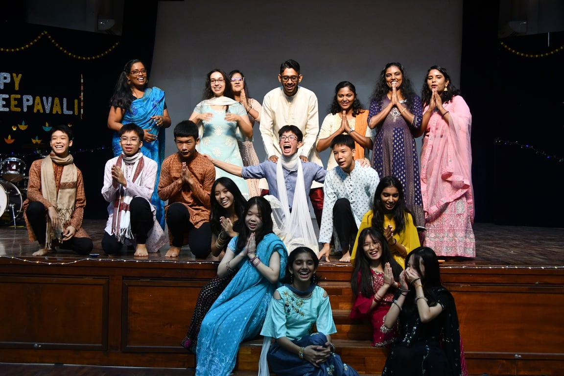 Students dressed in traditional Indian clothing posing during the Deepavali event.