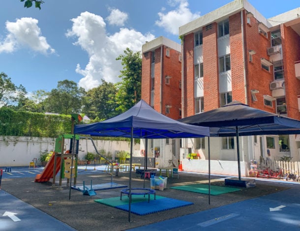 A view of the playground and school building, taken from the rear of the school