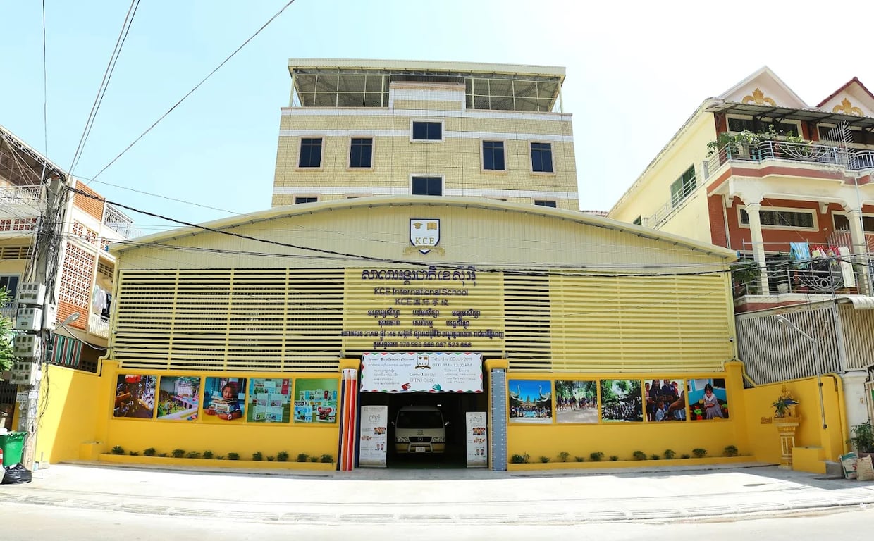 KCE International School main campus building in vibrant yellow color.
