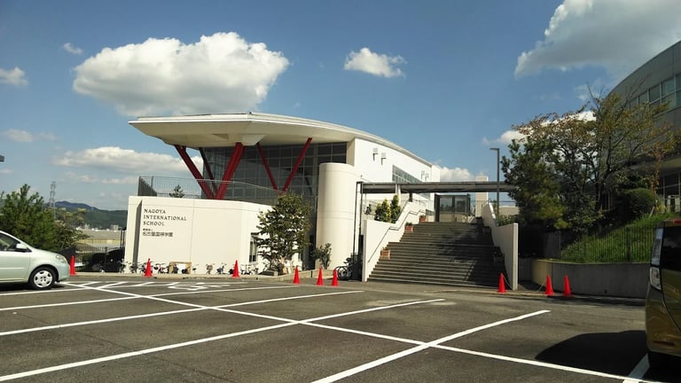 An exterior view of the school’s main entrance featuring unique structural supports.