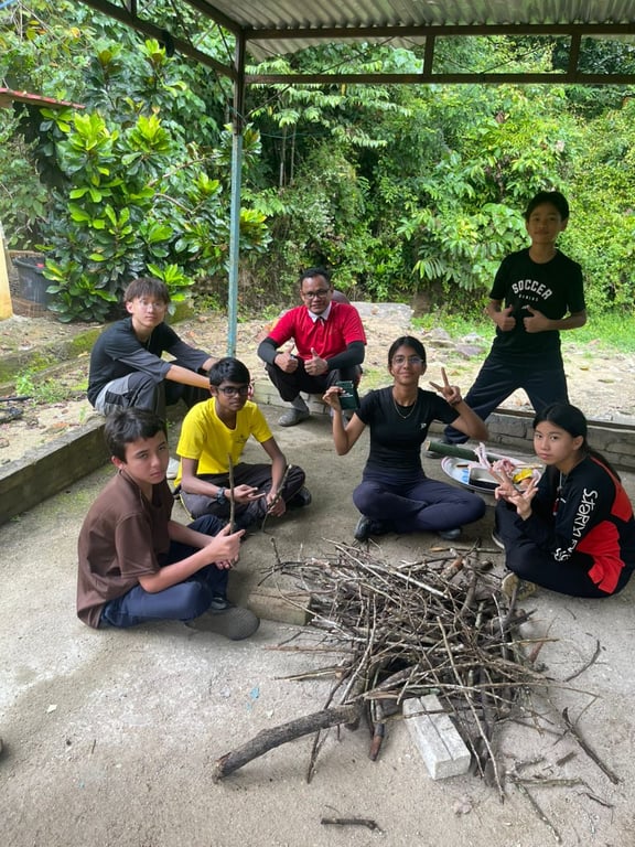 Students practise survival and leadership skills by preparing a fire structure as part of an outdoor education and campcraft programme.