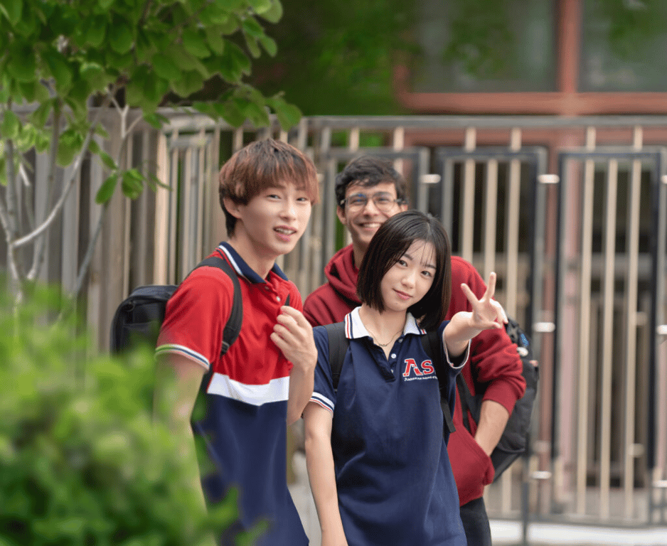 Students in uniforms near the campus entrance.