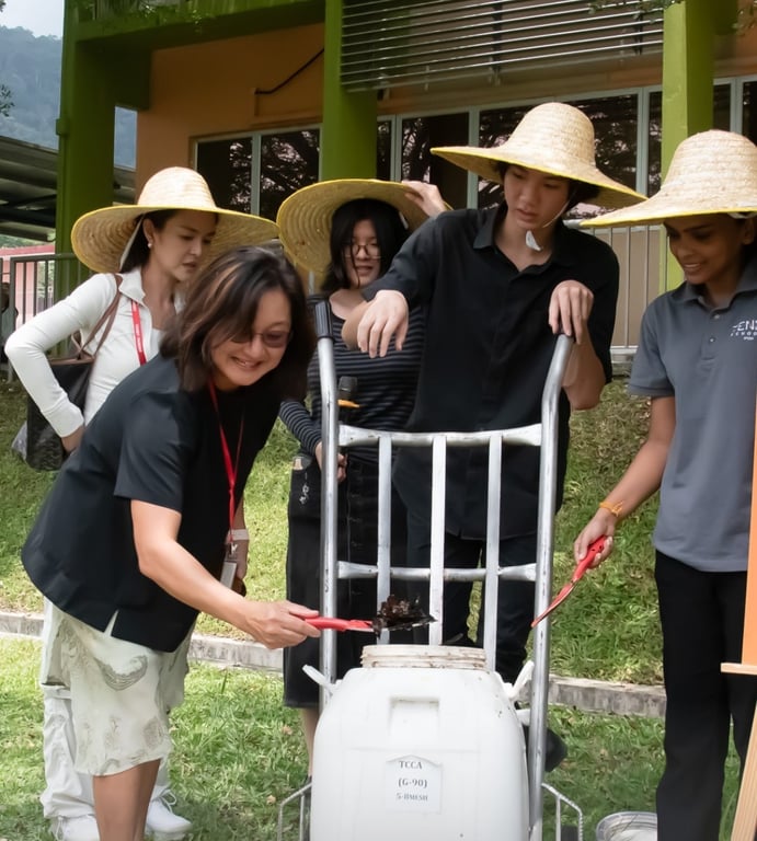 Secondary students, alongside parents, leading a composting Waste Management Project.