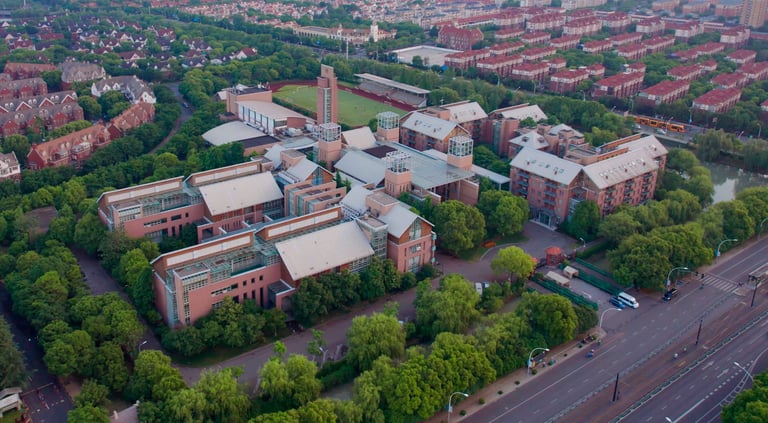 Aerial view of YK Pao School campus buildings and green playing field.