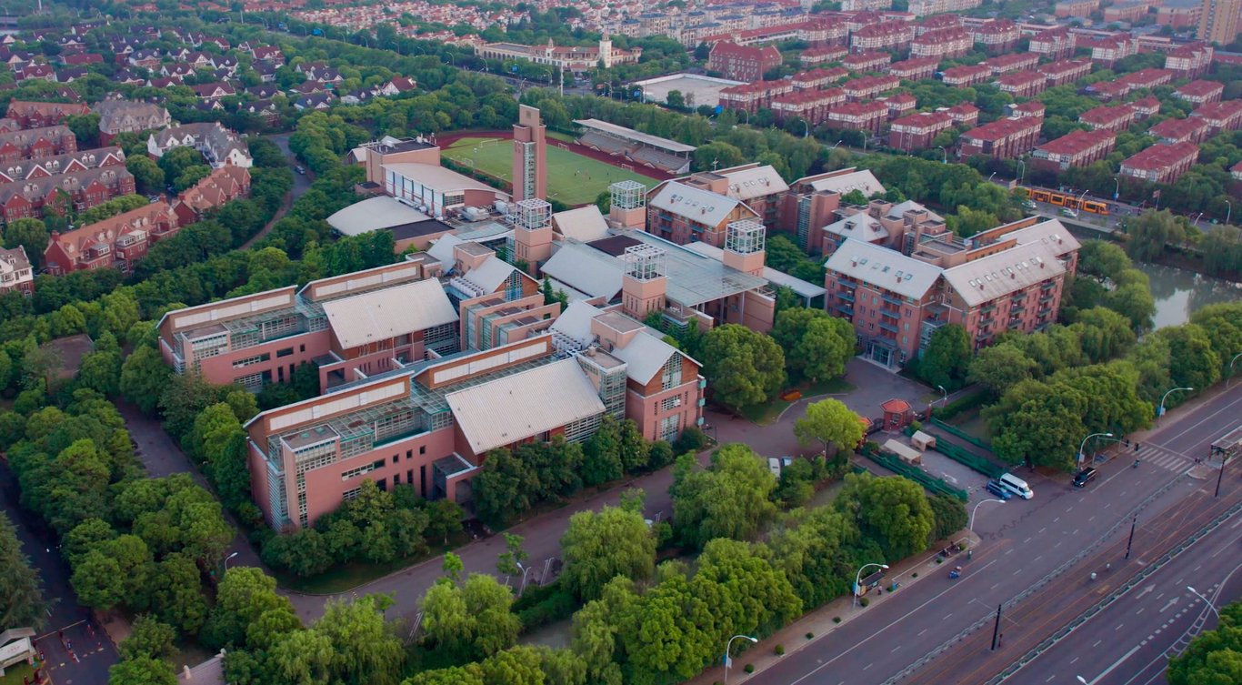Aerial view of YK Pao School campus buildings and green playing field.