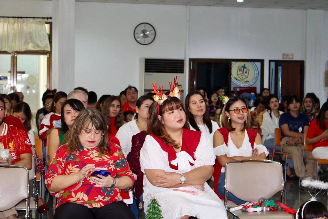 Parents watching children perform at the Christmas celebration event.