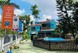The main school building and the swimming pool visible in the foreground